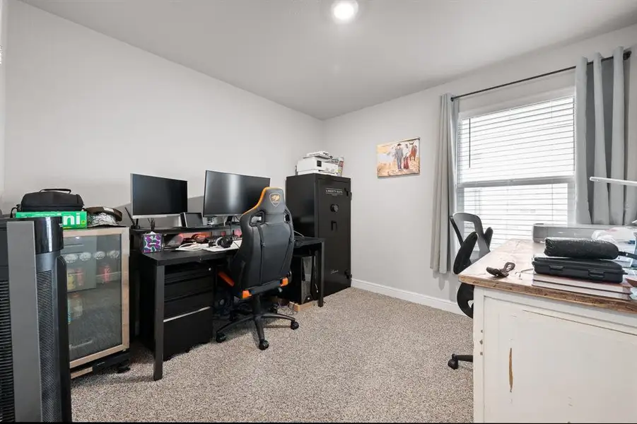 Home office featuring light colored carpet and baseboards Home office featuring light colored carpet and baseboards