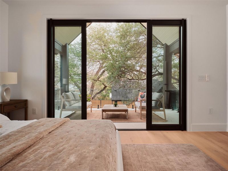 Bedroom featuring access to exterior and wood finished floors