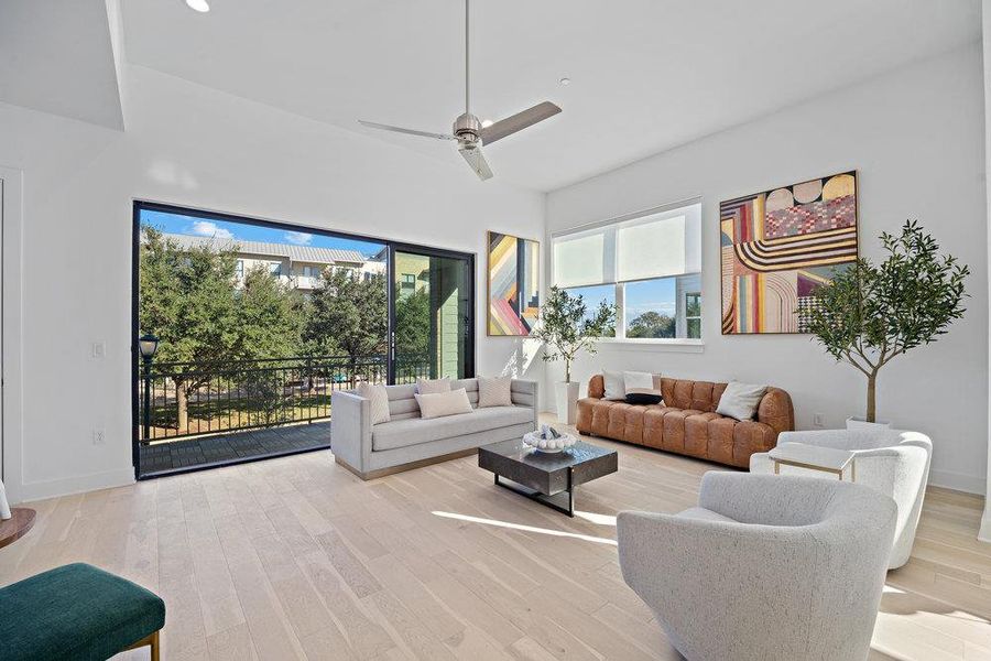 Living room with wood finished floors and a ceiling fan