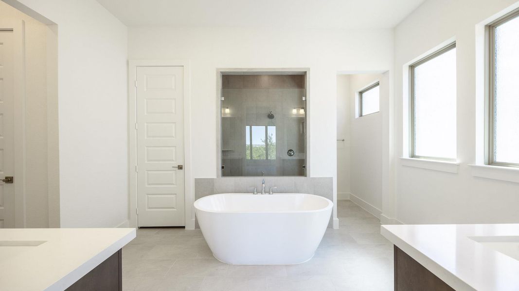 Full bathroom featuring vanity, a soaking tub, tiled shower, and tile patterned flooring Full bathroom featuring vanity, a soaking tub, tiled shower, and tile patterned flooring