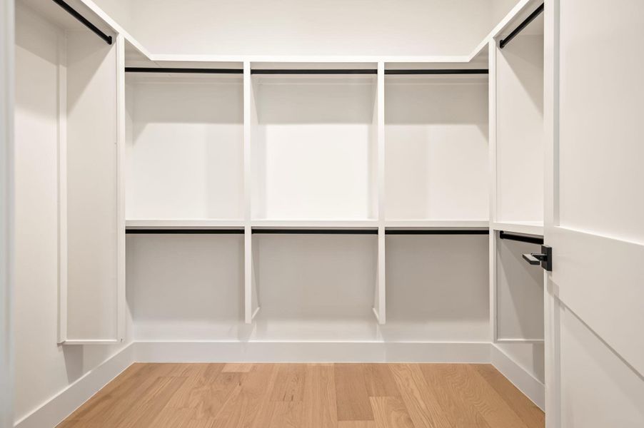 Custom shelving and hanging rods define this well-appointed, ready-to-organize closet space.