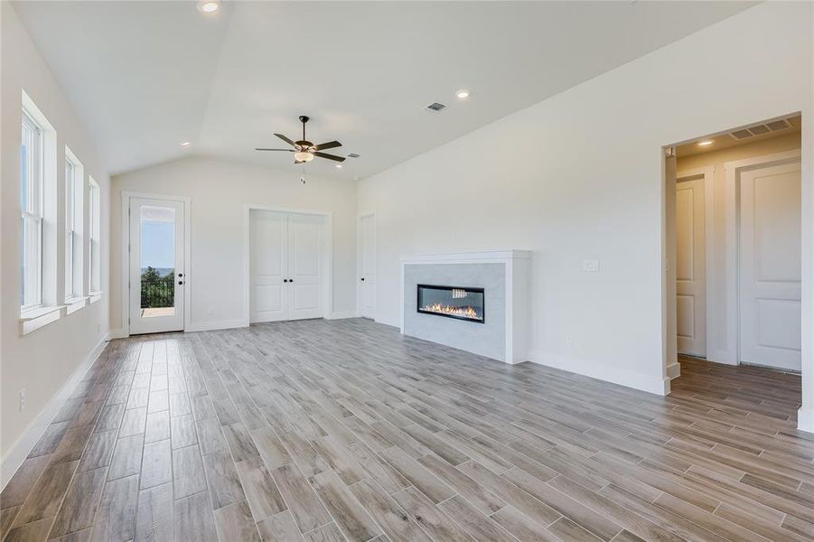 A cozy fireplace and ample light with back patio access make this room the place where all will like to gather.