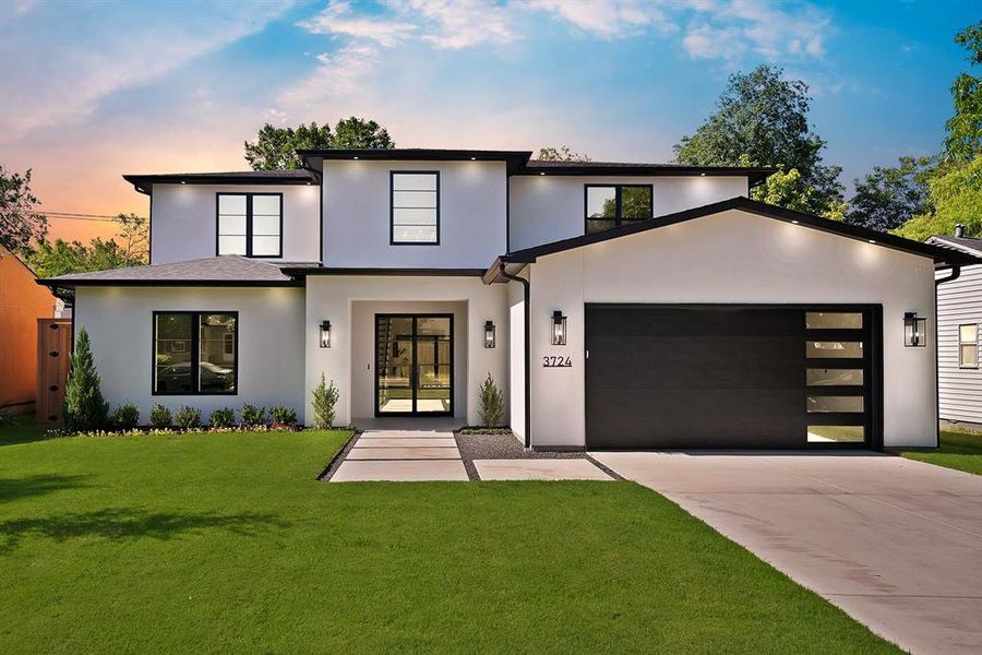 Contemporary two-story residence featuring a white stucco exterior and dark trim accents