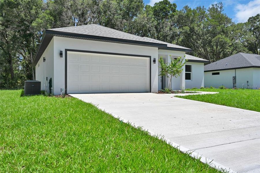 Front exterior of a new home in , Dunnellon, FL, highlighting curb appeal (Image 1). Front exterior of a new home in , Dunnellon, FL, highlighting curb appeal (Image 1).