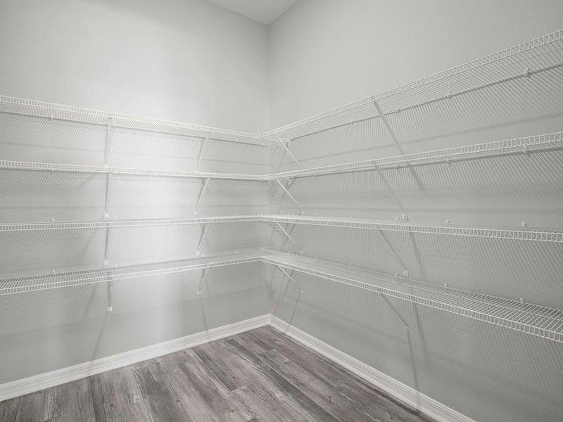 Enjoy the storage convenience of a walk-in pantry - Photos showcase a home with similar finishes, not the actual home for sale.
