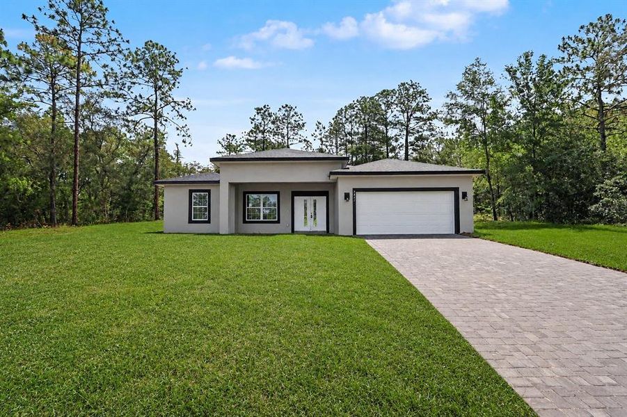 Front exterior of a new home in , Citrus Springs, FL, highlighting curb appeal (Image 24).