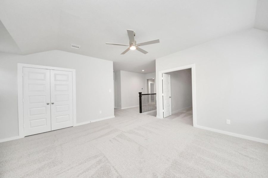 Come upstairs and enjoy a day of leisure in this fabulous game room! This is the perfect hangout spot or adult game room! Features plush carpet, high ceilings, custom paint and windows for plenty of natural light.