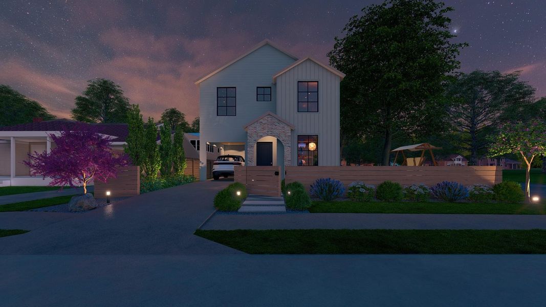 View of front facade with concrete driveway, stone siding, and a fenced front yard