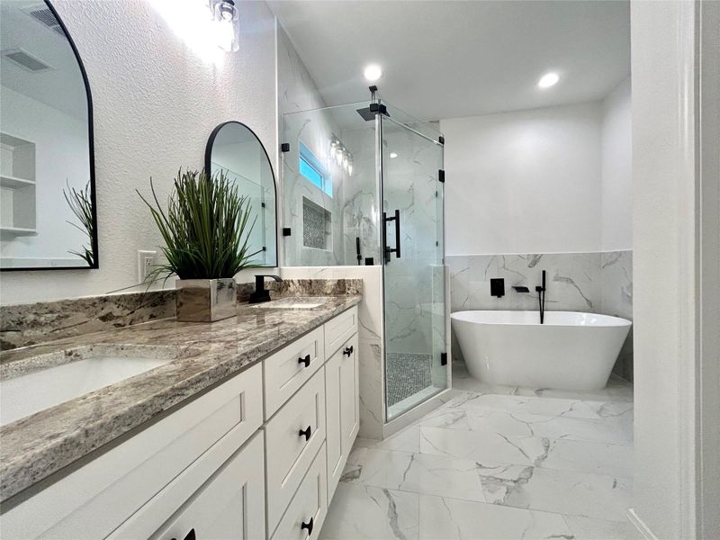 Primary bathroom with soak in tub and walk-in shower. Primary bathroom with soak in tub and walk-in shower.