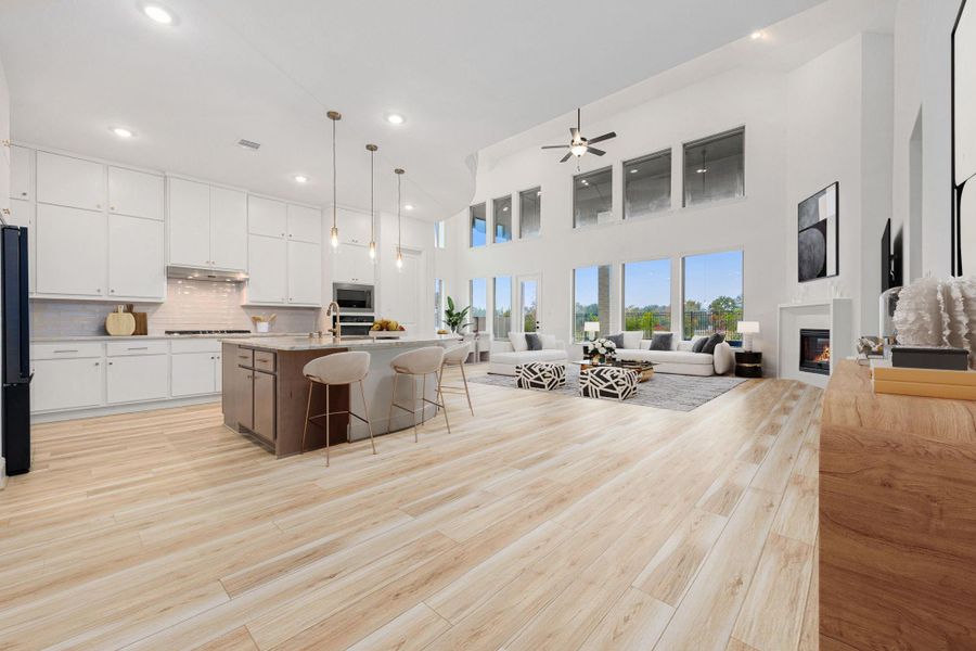 A spacious kitchen anchors the open layout, offering wood-look flooring and easy connection to the main living space.