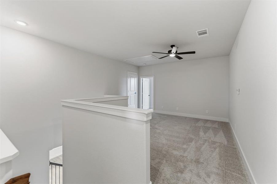 Empty room with light carpet and ceiling fan