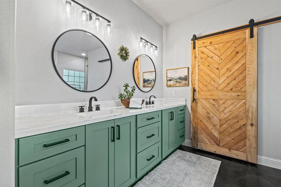 Bathroom with double vanity and baseboards Bathroom with double vanity and baseboards