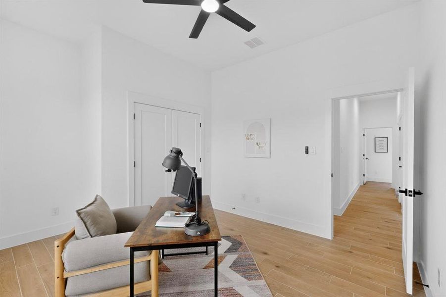 Living area with an office area, wood finish floors, and a ceiling fan