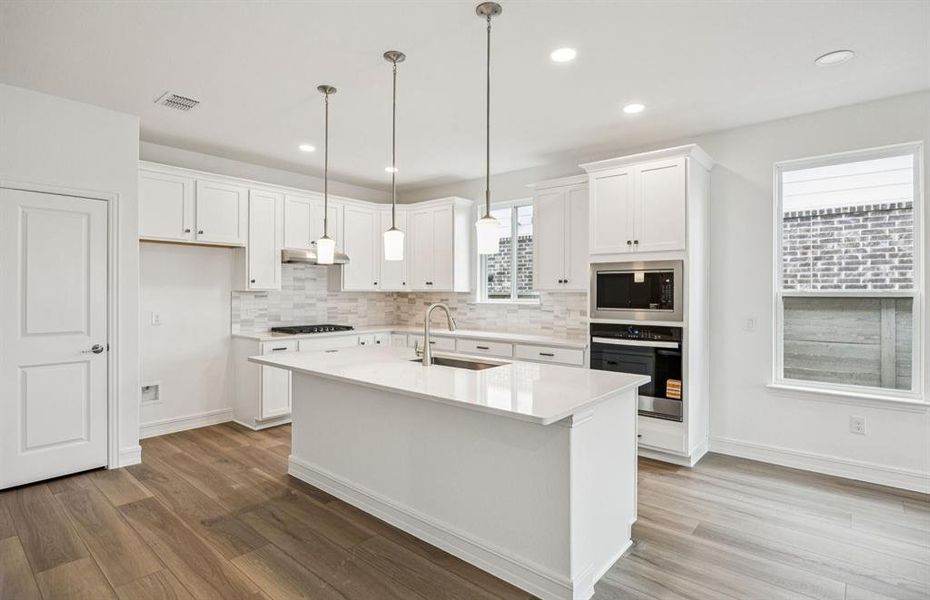 Eat in kitchen features large island *Real home pictured