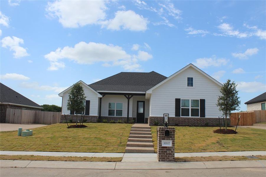 View of front of home featuring brick siding and roof with shingles View of front of home featuring brick siding and roof with shingles