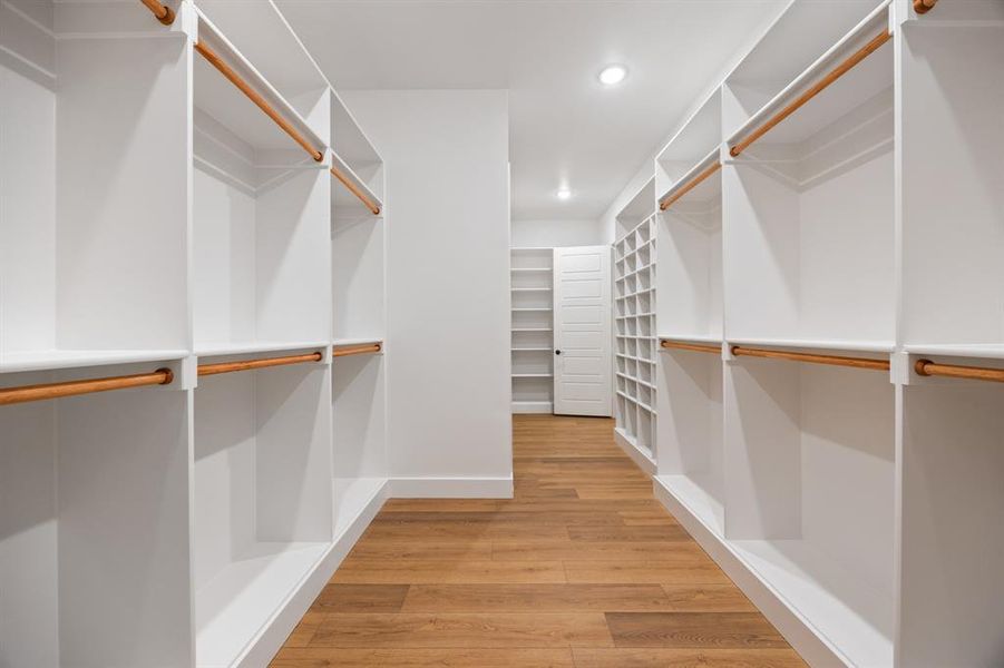 Spacious closet featuring light wood-type flooring