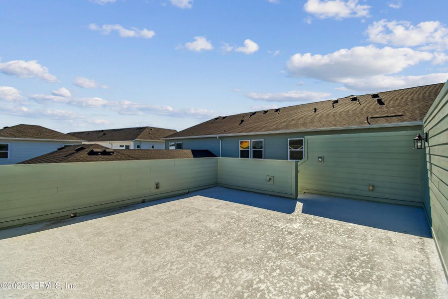 Exterior details and patio area of a home in Seven Pines 24' Rear Entry Townhomes, Jacksonville (Image 2).