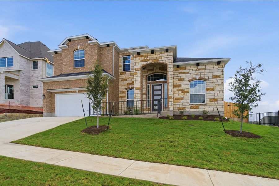Front exterior of a new home in Sunfield, Buda, TX, highlighting curb appeal (Image 2). Front exterior of a new home in Sunfield, Buda, TX, highlighting curb appeal (Image 2).