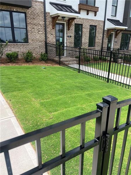 Exterior details and patio area of a home in Palisades Townhomes, Cumming (Image 28).