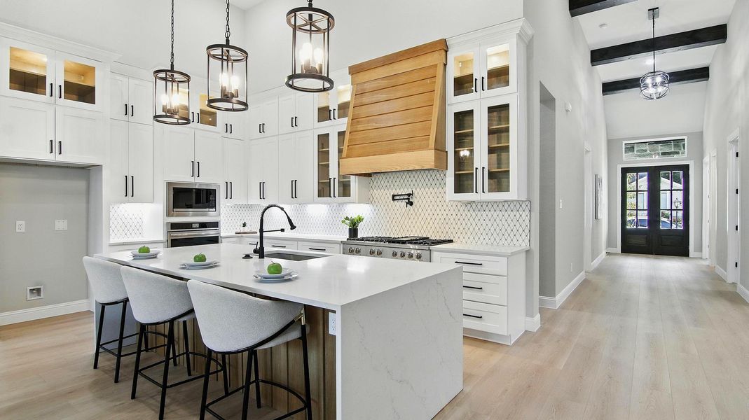 Natural wood range hood that adds warmth and contrast to to all-white design. Natural wood range hood that adds warmth and contrast to to all-white design.