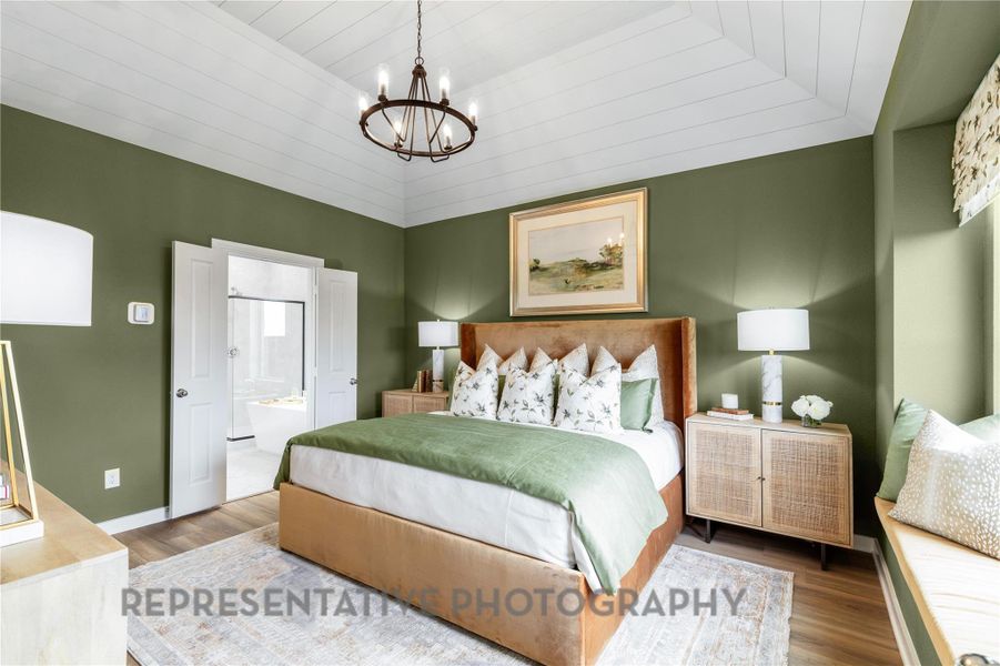 Bedroom featuring wood finished floors, a chandelier, wooden ceiling, and ensuite bath