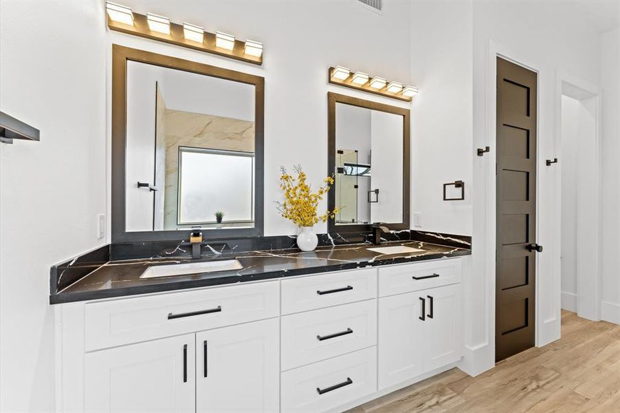 The master bathroom features a double vanity for added convenience and luxury.