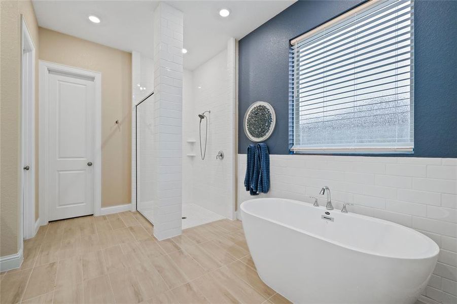 DUAL SINKS. WHITE SUBWAY TILE SURROUND IN SEPARATE SHOWER. FREE STANDING TUB.