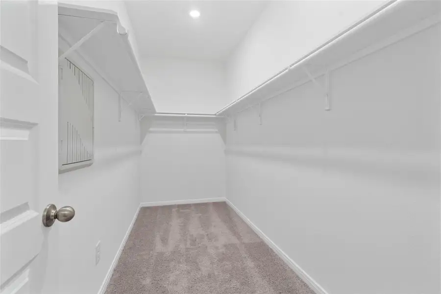 This primary walk-in closet will not disappoint! With high shelving, multiple rows to hang clothing, you are sure to have enough room for all your belongings!