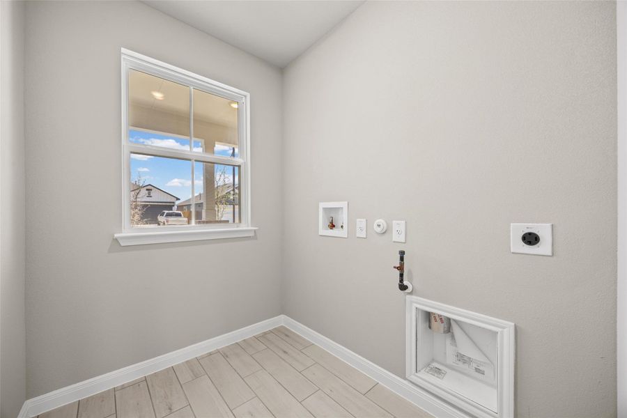 Tiled flooring and a bright window highlight this functional utility space. Tiled flooring and a bright window highlight this functional utility space.