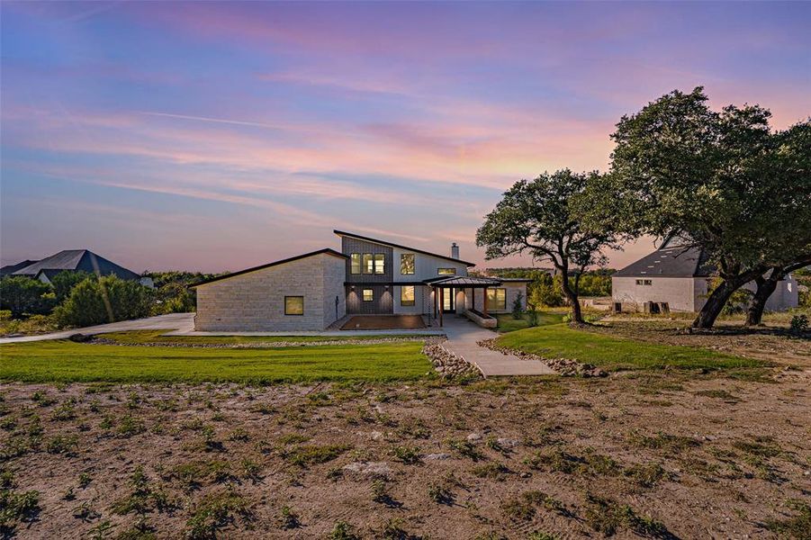 View of front of property with a front lawn and a patio View of front of property with a front lawn and a patio