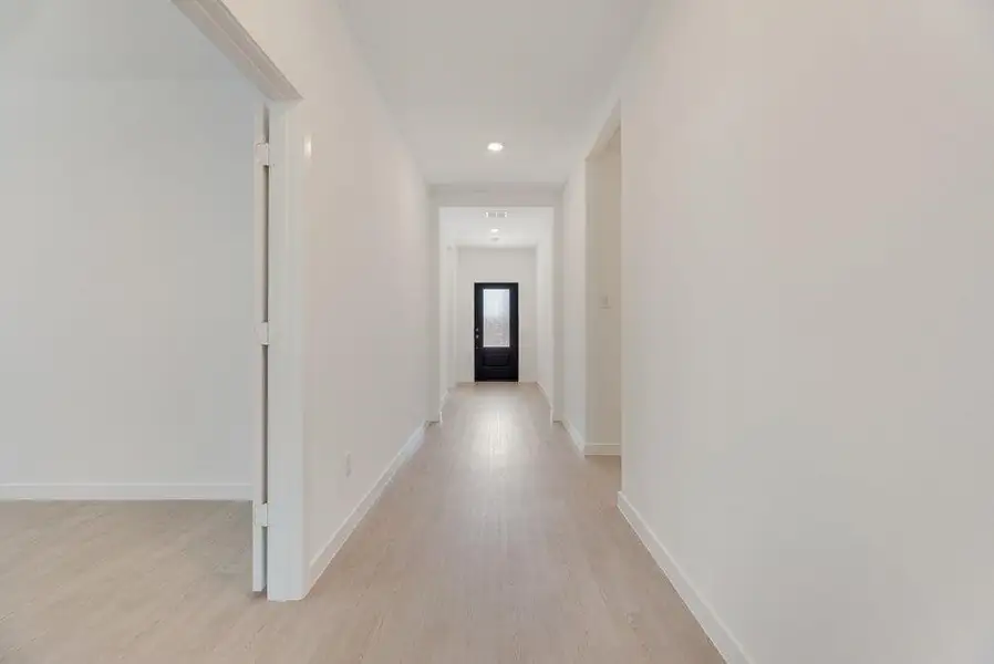 Hallway featuring light wood-style floors and recessed lighting