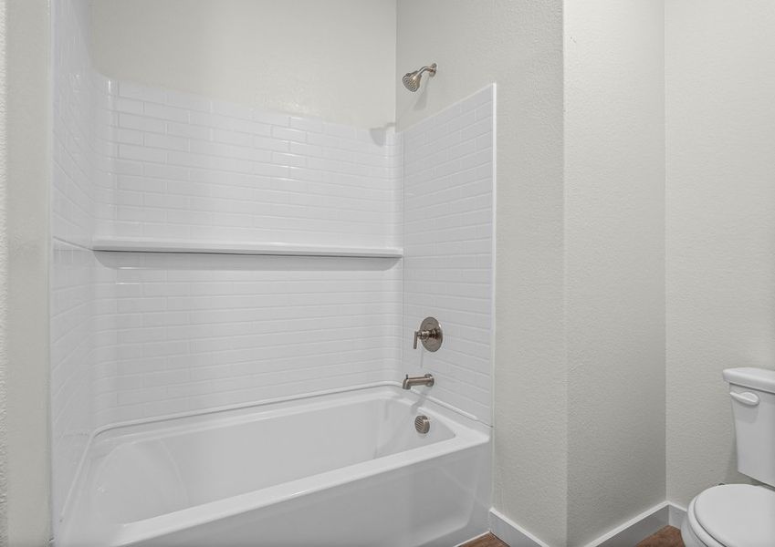 The secondary bathroom has a shower-tub combo.