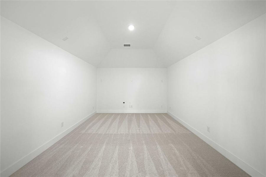 Bonus room featuring light colored carpet, lofted ceiling, and recessed lighting Bonus room featuring light colored carpet, lofted ceiling, and recessed lighting
