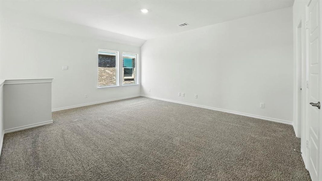 Empty room with carpet, vaulted ceiling, and recessed lighting