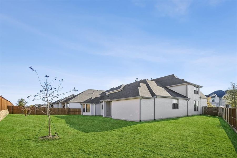 Rear view of property with a fenced backyard and roof with shingles Rear view of property with a fenced backyard and roof with shingles