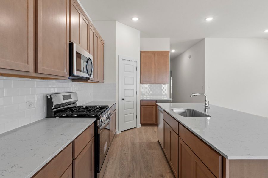 Kitchen in the Quartz home plan by Trophy Signature Homes – REPRESENTATIVE PHOTO