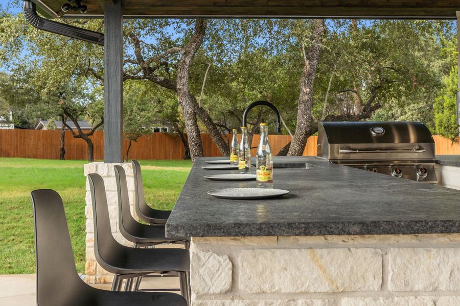 Indulge in the poolside outdoor kitchen and bar—an entertainer's dream come to life.