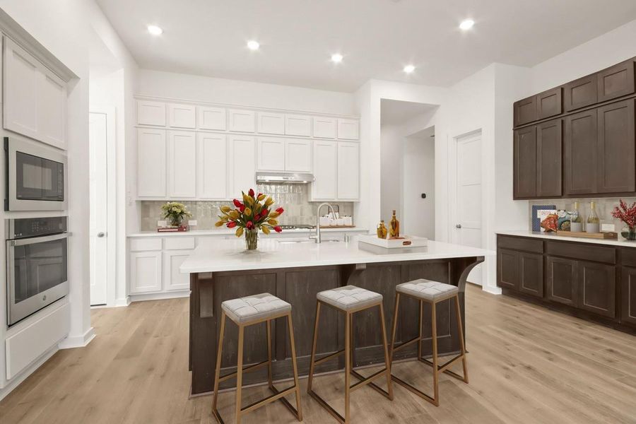 Virtually Staged - Beautifully designed kitchen highlighting a built-in hutch, stacked cabinetry, and a large central island, blending elevated storage with a highly functional layout!