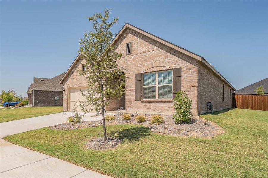 View of front of home with brick siding, a front lawn, concrete driveway, and a garage View of front of home with brick siding, a front lawn, concrete driveway, and a garage