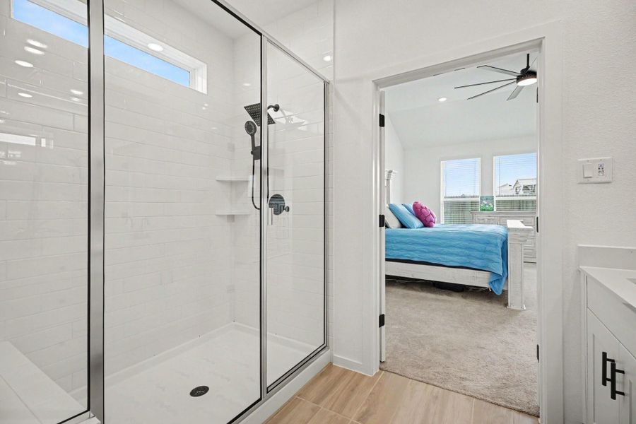 Oversized walk-in shower with frameless glass enclosure, modern fixtures, built-in shelving, and a clean, contemporary design. Oversized walk-in shower with frameless glass enclosure, modern fixtures, built-in shelving, and a clean, contemporary design.