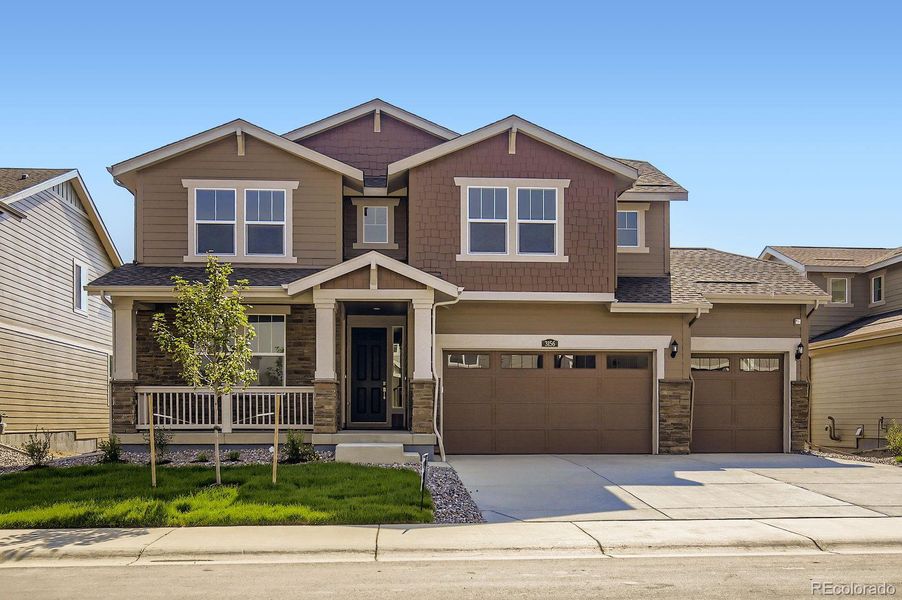 Front exterior of a new home in Riano Ridge: The Grand Collection, Loveland, CO, highlighting curb appeal (Image 1).