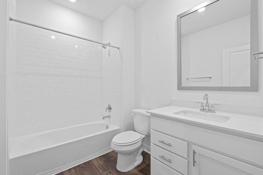 Full bath featuring dark wood-type flooring, tub / shower combination, and vanity Full bath featuring dark wood-type flooring, tub / shower combination, and vanity