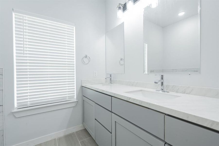 Bathroom featuring tile patterned flooring and vanity