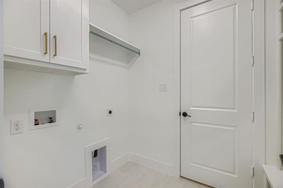 Laundry room featuring cabinet space, hookup for a gas dryer, washer hookup, and electric dryer hookup
