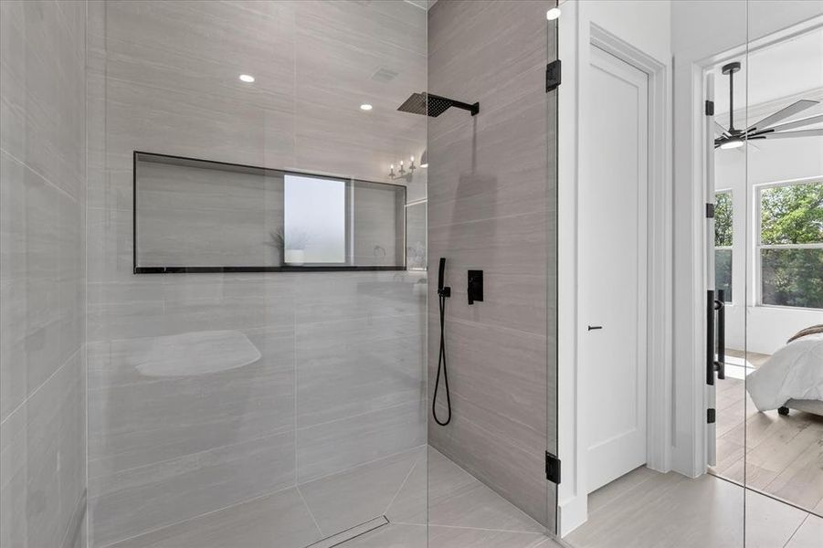 Ensuite bathroom with walk in shower and a ceiling fan