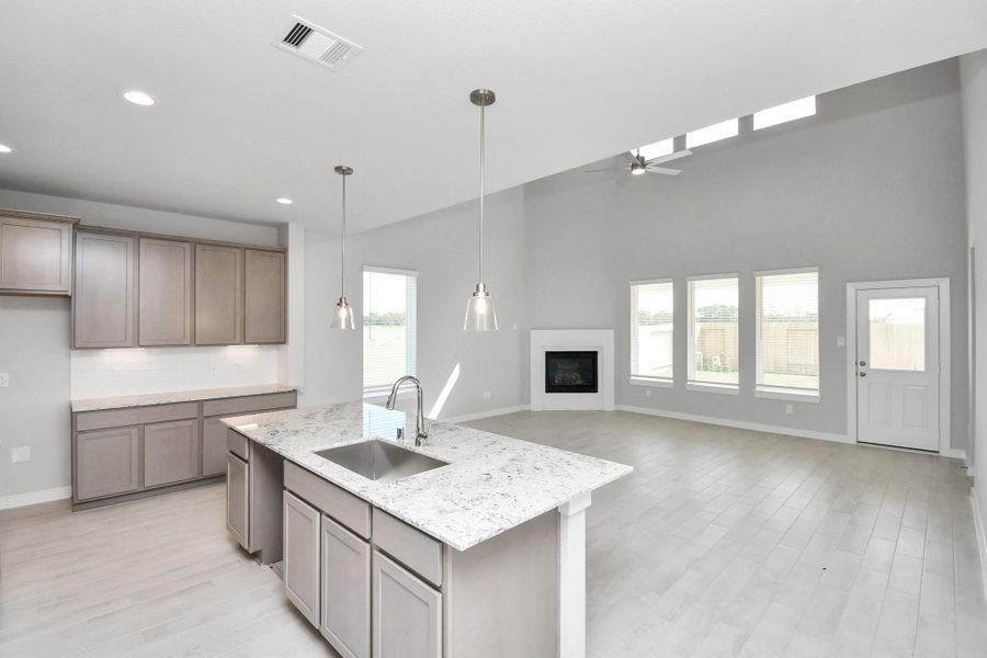 All of this overlooks your expansive family room, creating a perfect space for culinary delights and family gatherings. Sample photo of completed home with similar floor plan. Actual colors and selections may vary. All of this overlooks your expansive family room, creating a perfect space for culinary delights and family gatherings. Sample photo of completed home with similar floor plan. Actual colors and selections may vary.