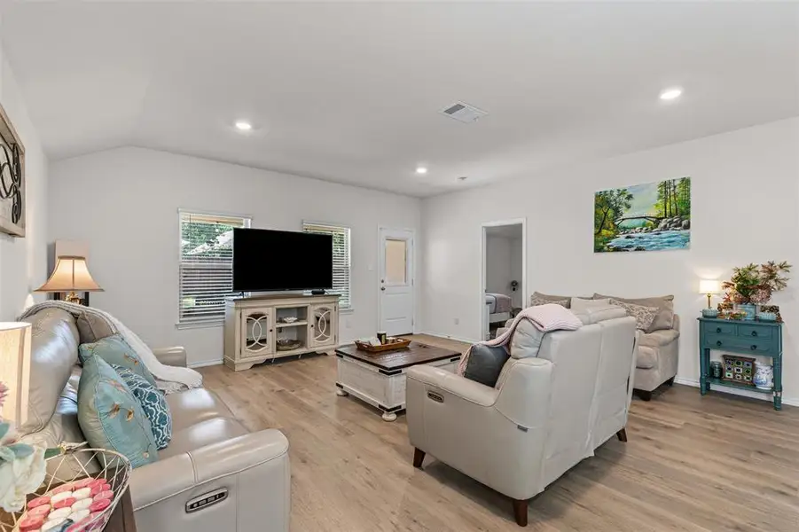 Spacious open-layout living area with modern recessed lighting and seamless flow into the kitchen and dining spaces. Spacious open-layout living area with modern recessed lighting and seamless flow into the kitchen and dining spaces.