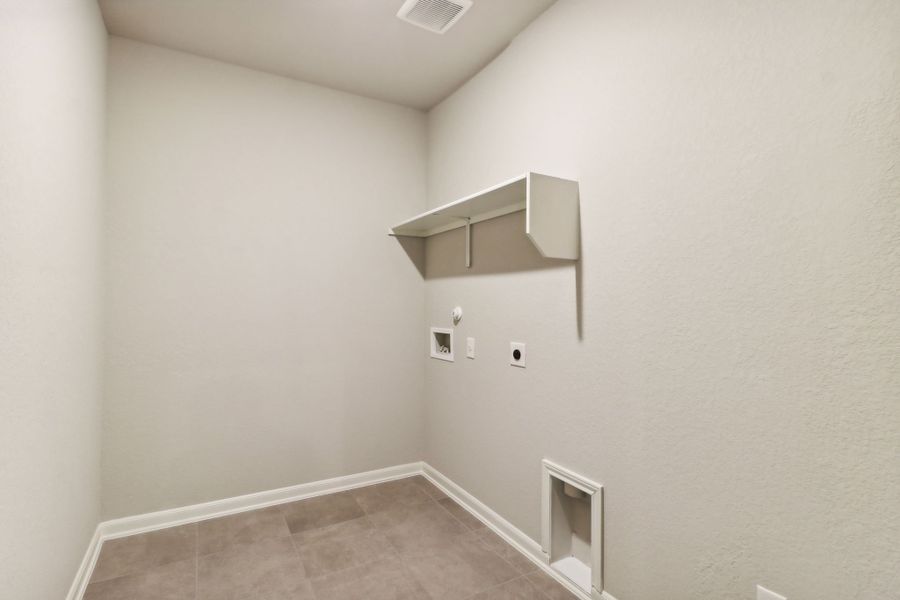 Laundry room in the Hughes floorplan at a Meritage Homes community.