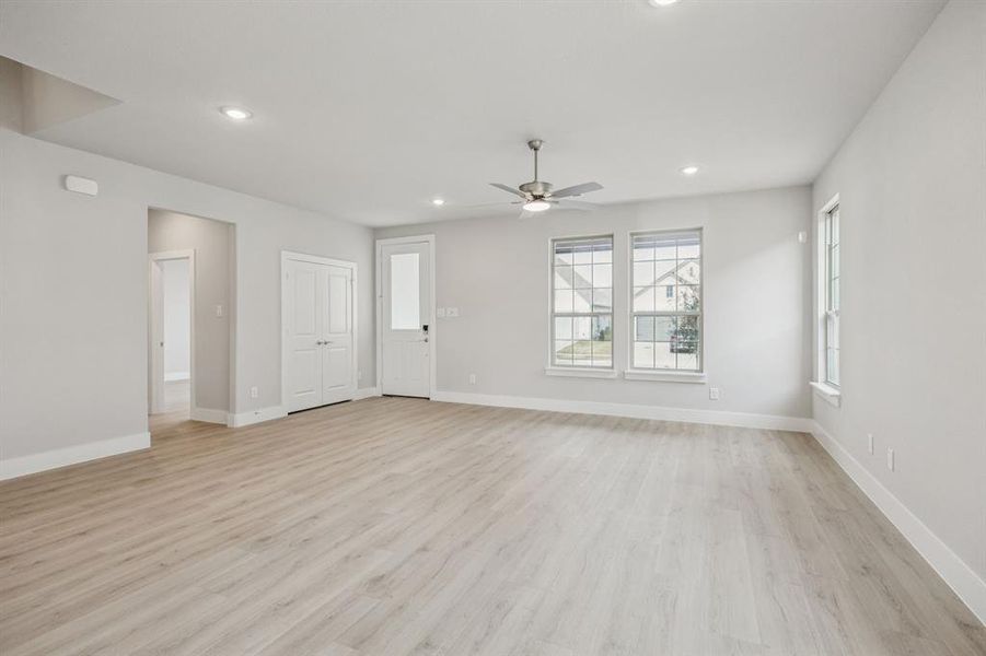 Unfurnished living room featuring light wood-style floors, recessed lighting, and ceiling fan Unfurnished living room featuring light wood-style floors, recessed lighting, and ceiling fan