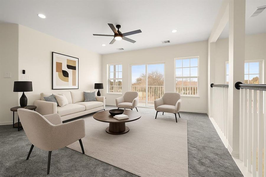 Living area featuring light carpet, plenty of natural light, ceiling fan, and recessed lighting Living area featuring light carpet, plenty of natural light, ceiling fan, and recessed lighting